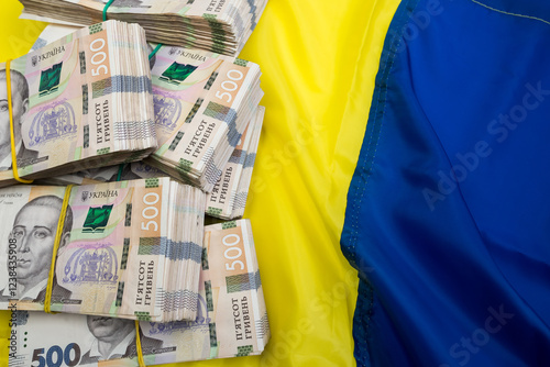 Ukrainian Money on national flag blue yellow, finance conccept. photo