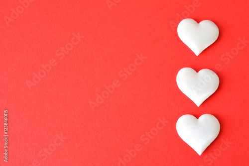 Three White Hearts on the left side of the Red background copy sace photo