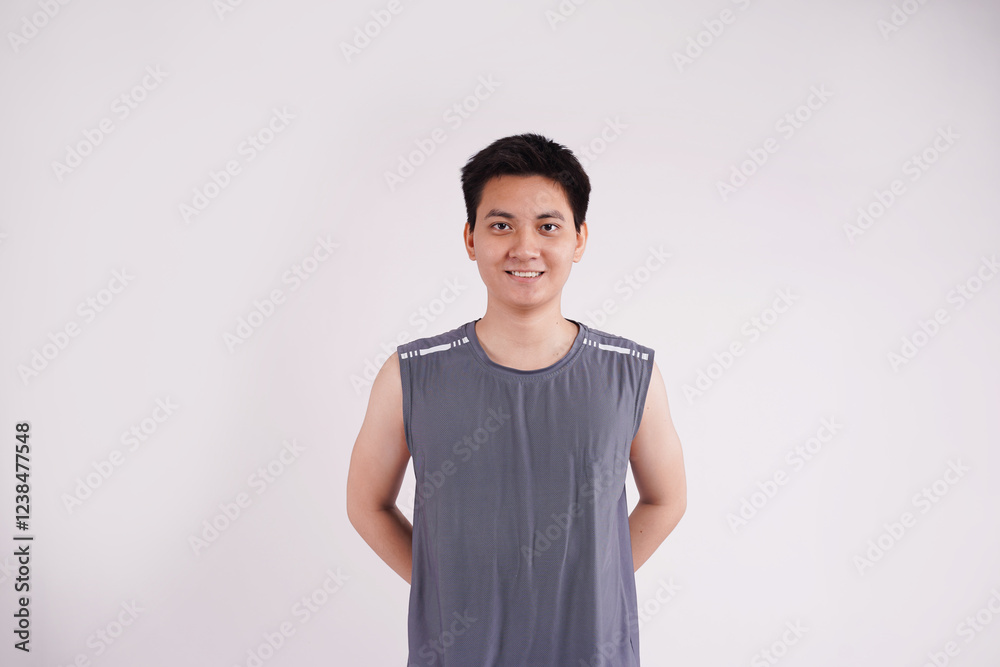 Image of an Asian guy wearing gym clothes posing on a white background