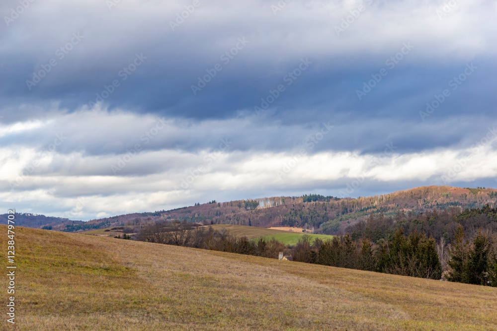 A landscape with forested hills in early spring.