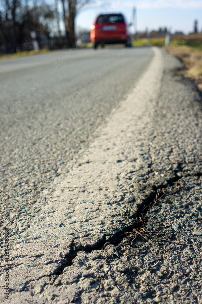 Cracks in a road asphalt due to frost in winter vertical Cracks in a road asphalt due to frost in winter vertical