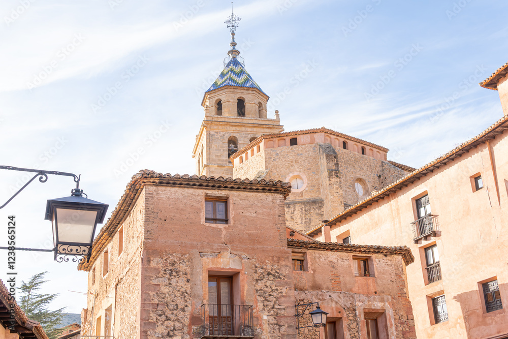 Cathedral of the Savior of Albarracín Teruel Spain. View from an old street of the historical and monumental complex with old street lamp and stone house. Albarracín Most beautiful village in Spain. Cathedral of the Savior of Albarracín Teruel Spain. View from an old street of the historical and monumental complex with old street lamp and stone house. Albarracín Most beautiful village in Spain.