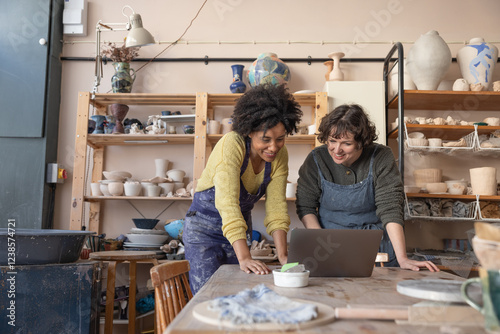 Two women starting a craft business looking at a laptop computer