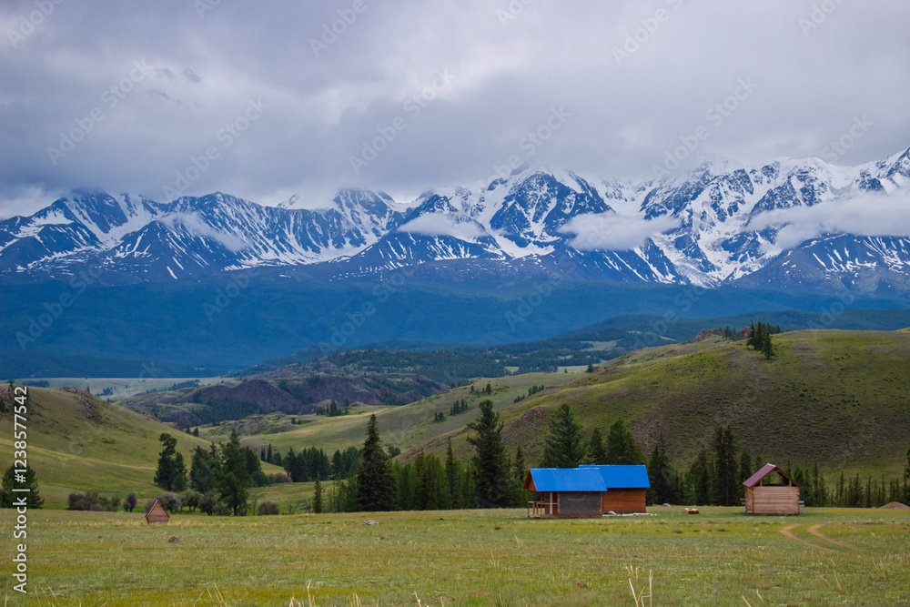 Altai summer landscape with North Chuya mountain range in Altai Republic, Russia. View from the Kurai Steppe on snow-capped Altai Mountains hidden thick cloudy Altai summer landscape with North Chuya mountain range in Altai Republic, Russia. View from the Kurai Steppe on snow-capped Altai Mountains hidden thick cloudy