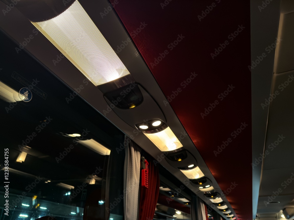 Interior of luxury bus, ceiling with lights on