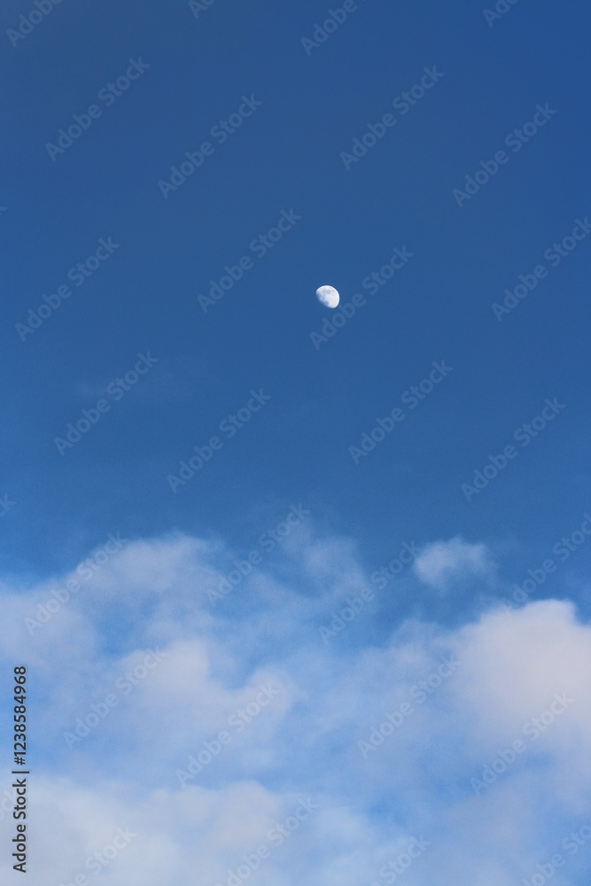 Half Moon Above Clouds on a Blue Sky Half Moon Above Clouds on a Blue Sky