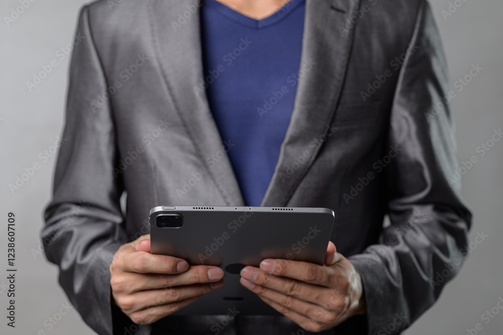 Businessman Using Digital Tablet in Modern Professional Setting Businessman Using Digital Tablet in Modern Professional Setting