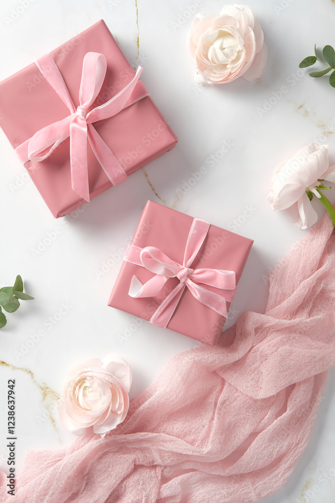 Pink gift boxes with ribbons, surrounded by delicate flowers and a pink fabric on a marble background. Ideal for celebrations, weddings, or romantic themes Pink gift boxes with ribbons, surrounded by delicate flowers and a pink fabric on a marble background. Ideal for celebrations, weddings, or romantic themes