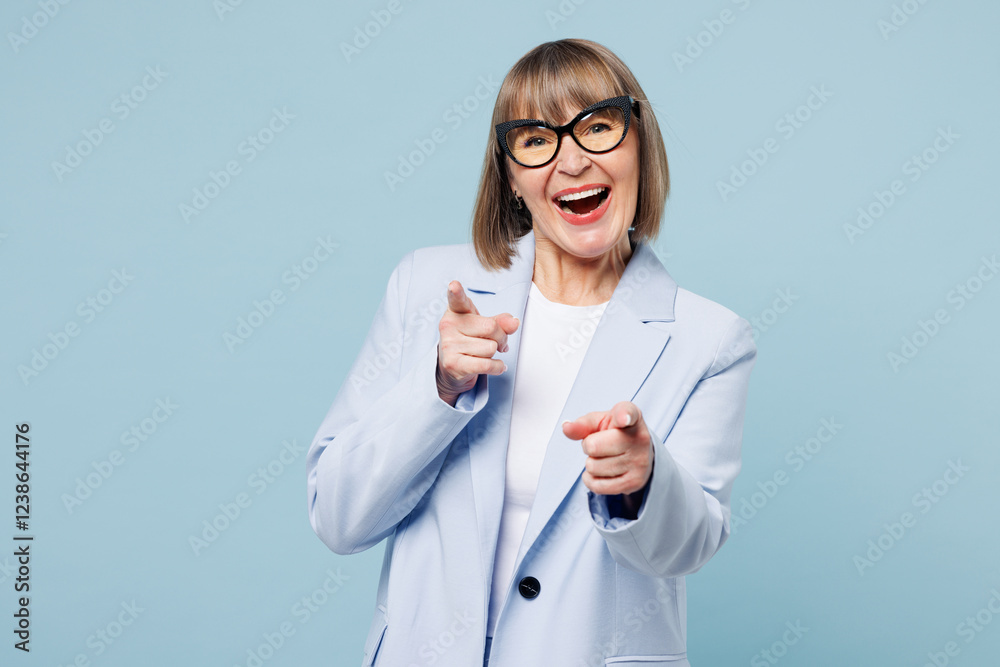 Blonde leader successful employee business woman 50s wear classic suit glasses formal clothes point index finger camera on you isolated on plain pastel light blue background. Lifestyle work concept. Blonde leader successful employee business woman 50s wear classic suit glasses formal clothes point index finger camera on you isolated on plain pastel light blue background. Lifestyle work concept.