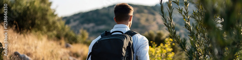 Man with Backpack Hiking in Hilly Terrain