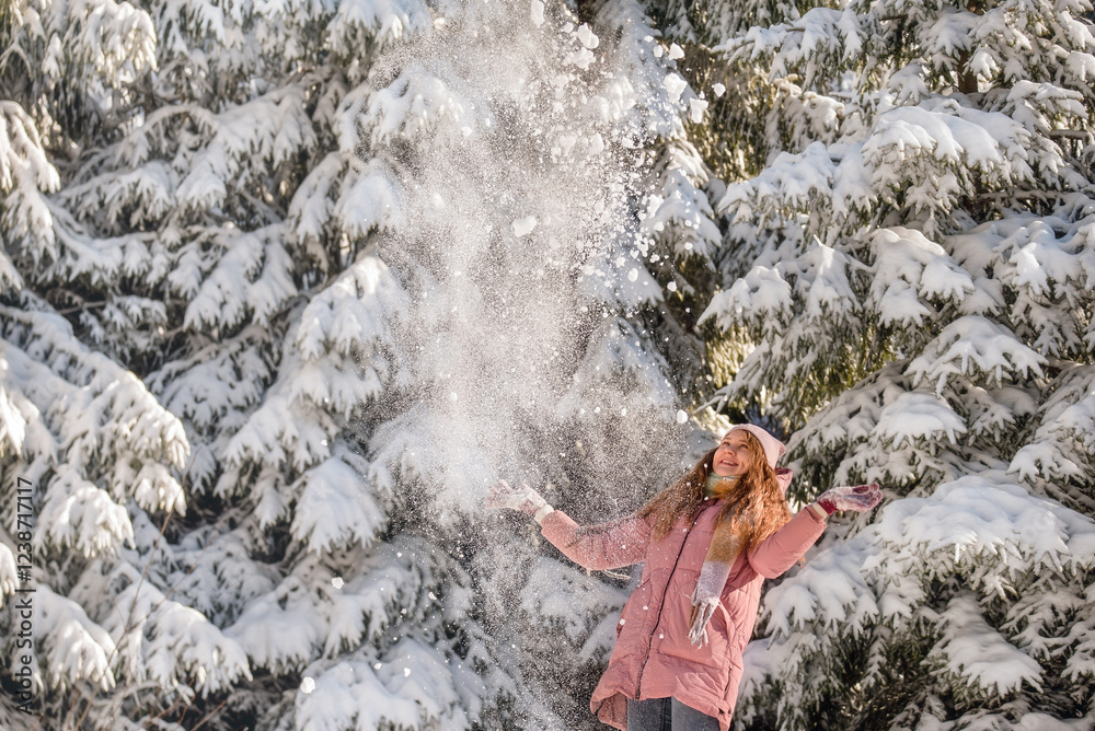 Happy Women Throwing Snow in Winter Forest