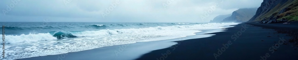 Obraz premium A serene black sand beach with crashing waves under a moody sky.