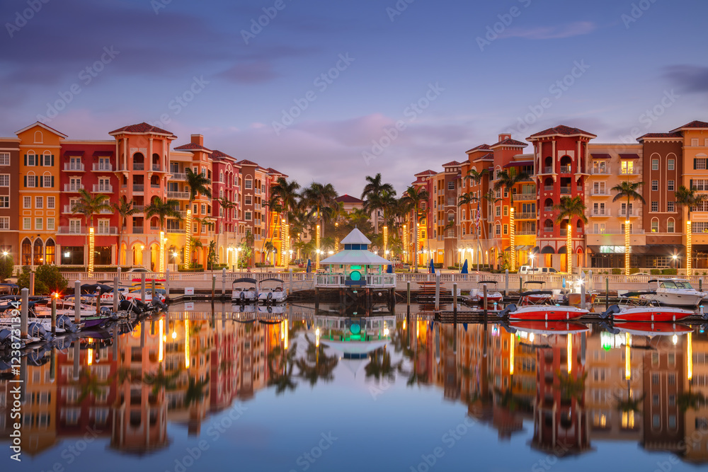 Naples, Florida, USA. Cityscape image of Naples, Florida with reflection of the city skyline in the water at beautiful sunrise.