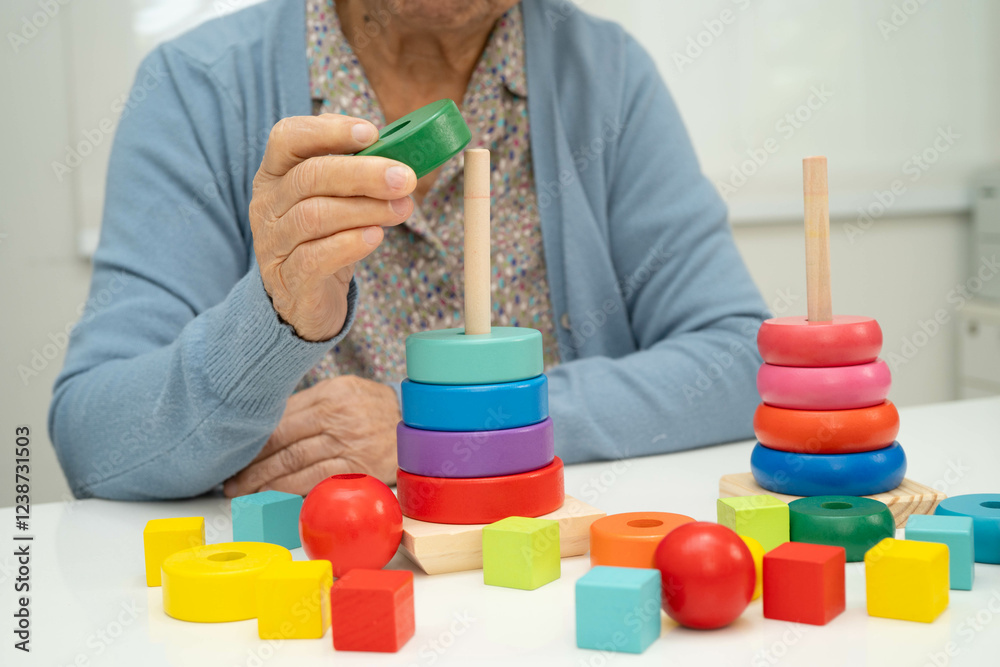 Asian elderly woman playing enhancing skill board game. Asian elderly woman playing enhancing skill board game.