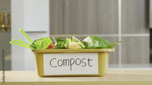 Home composting of food and vegetable waste for sustainability. Leftover vegetables collected in a compost bin for organic fertilizer. Organic waste, food scraps, natural compost, sustainable