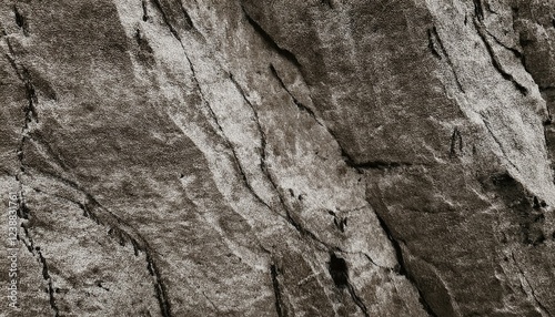 Dark gray brown rock texture. Rough mountain surface with cracks and scratches. Close-up. Grunge. Stone granite background with space for design. Backdrop. Web banner. Wide. Panoramic.