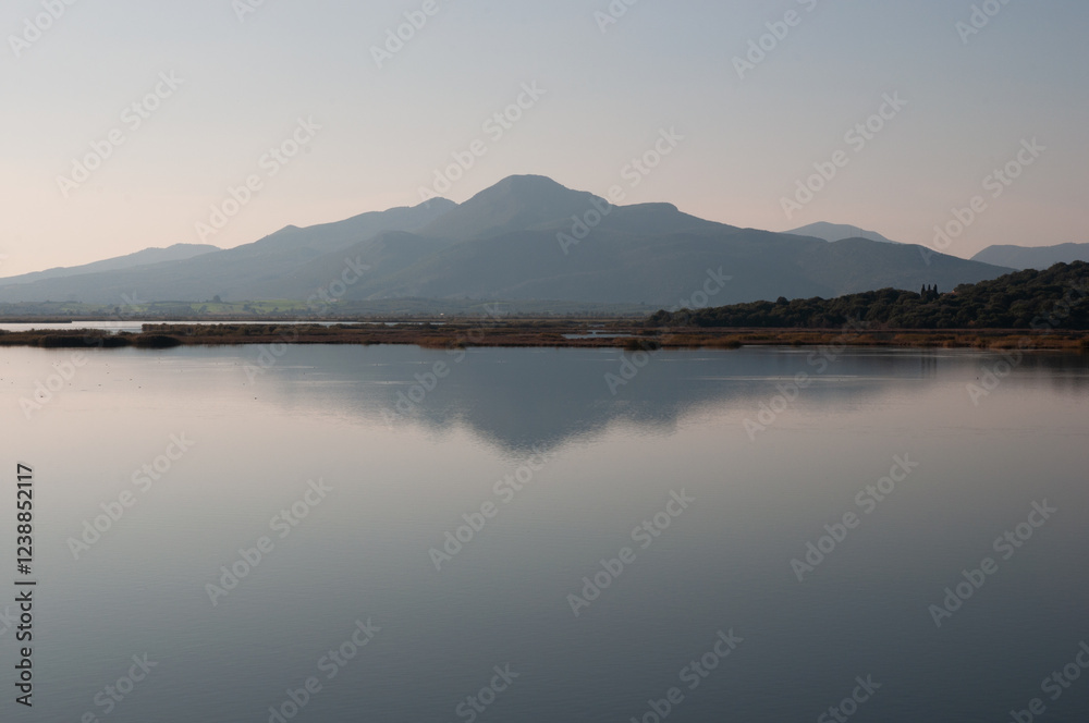 A landscape of a mountain reflected in the waters of a lagoon in Rhodia Arta. Epirus, Greece A landscape of a mountain reflected in the waters of a lagoon in Rhodia Arta. Epirus, Greece
