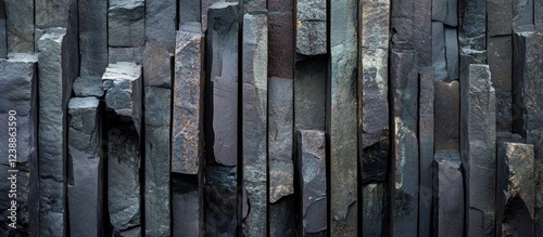 Textured slate stone wall with vertical rectangular slabs varying in color and thickness suitable for background use. Copy Space photo