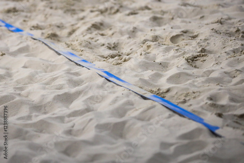 Indoor Beach Volleyball Game Court Blue side line with sand. Photo taken in indoor arena.