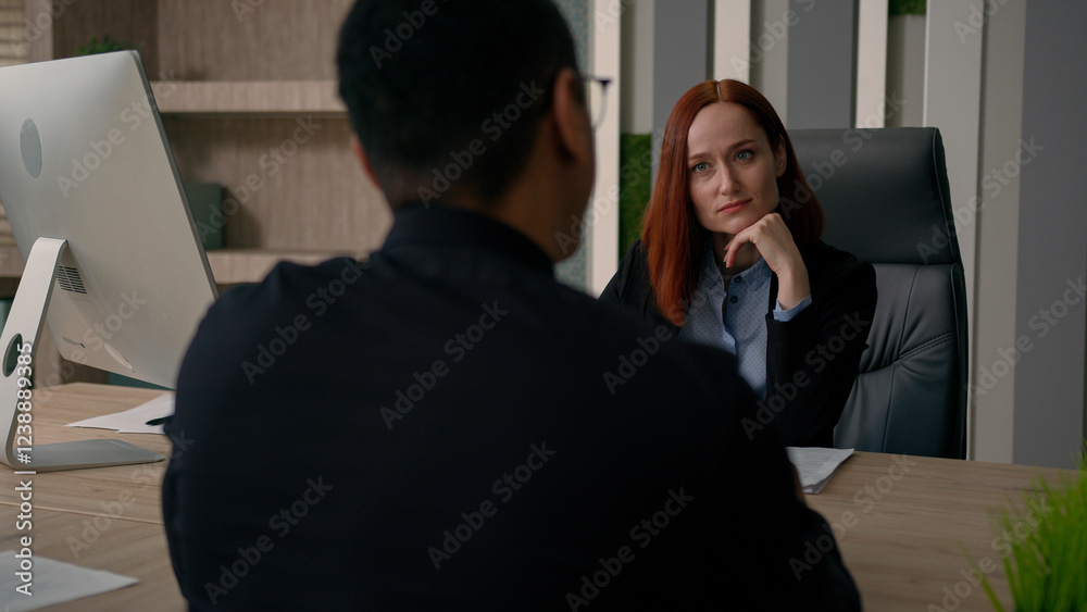 Fototapeta premium Two colleagues partners multiracial African american businessman Caucasian businesswoman talk in office business negotiation discuss deal startup financial investment bank insurance offer negotiate