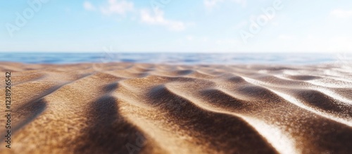 Sandy beach landscape with gentle waves and clear blue sky in the background Copy Space photo