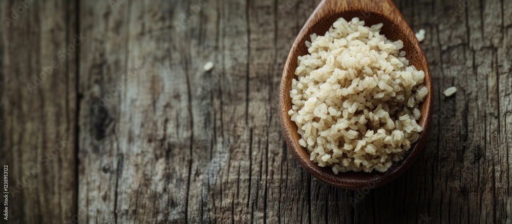 Brown bulgur wheat grains in a wooden spoon on a rustic wooden surface with natural lighting and texture Copy Space Brown bulgur wheat grains in a wooden spoon on a rustic wooden surface with natural lighting and texture Copy Space