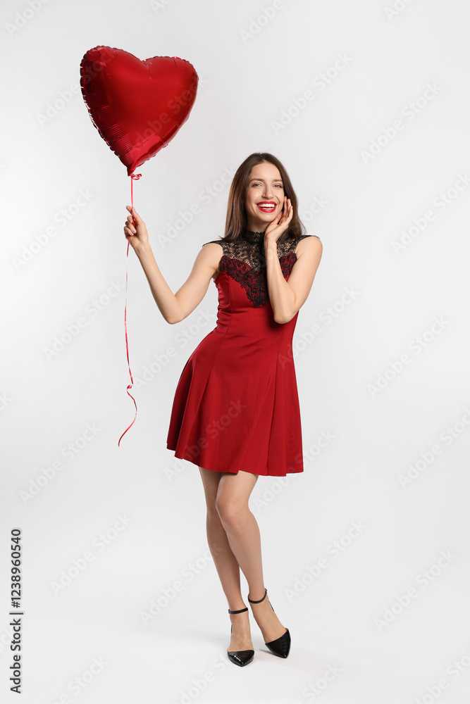 Happy Valentine's Day. Beautiful woman with heart shaped balloon on white background Happy Valentine's Day. Beautiful woman with heart shaped balloon on white background