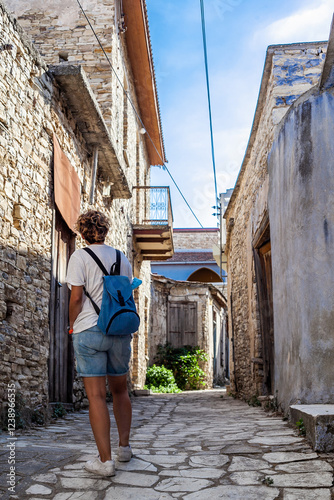 Tourist walking in narrow street exploring lofou village in cyprus