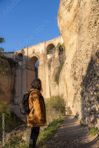 Tourist enjoying puente nuevo and el tajo gorge in ronda, malaga, spain