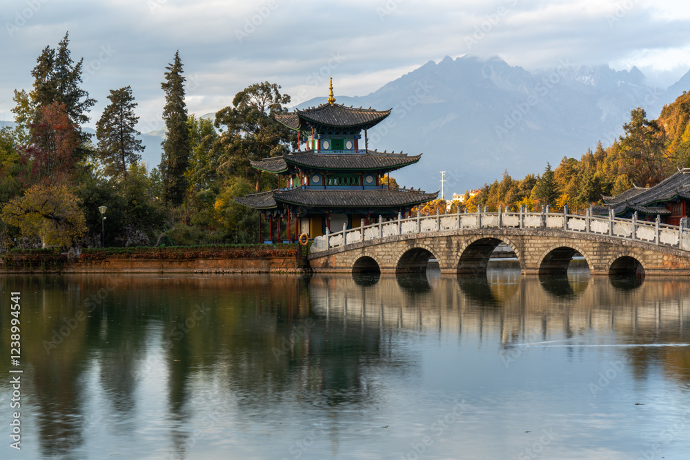 Fototapeta premium Scenic View of Jade Dragon Snow Mountain and Black Dragon Pool with Suocui Bridge and Moon Embracing Pavilion, Lijiang, Yunnan, China