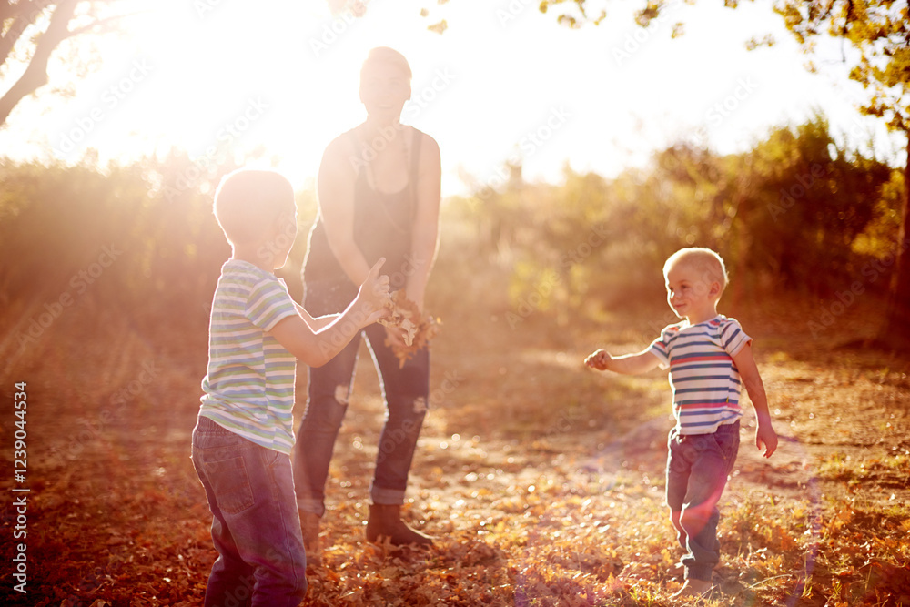 Fototapeta premium Happy, leaves and mom with children in nature for playing games, bonding and have fun together. Family, park and mother with kid excited for season change, autumn or fall for childhood outdoors