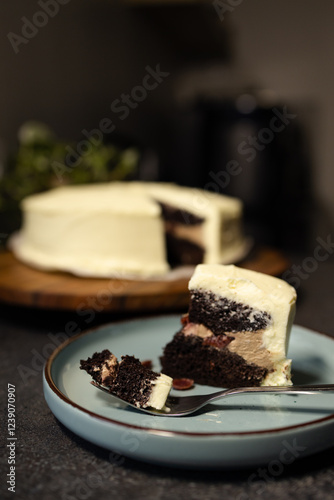 vertical shot of chocolate cake with Cream Cheese Frosting on a plate