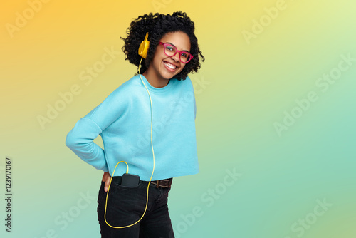 Happy African American young woman dressed in casual clothes smiling over colorful background