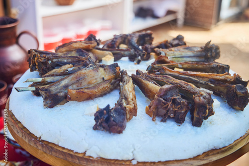 Meat ribs cooked on the grill, lie on the porridge. A traditional dish of the peoples of the Caucasus photo