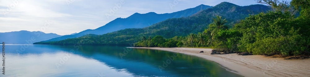 A beautiful mountain range with a lake in the foreground. The lake is calm and the mountains are covered in lush green trees. The scene is serene and peaceful, with the water reflecting the mountains