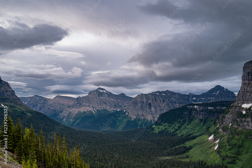 Majestic view from the Going to the Sun road in Glacier of the mountain peaks, and the deep valley in Montana Majestic view from the Going to the Sun road in Glacier of the mountain peaks, and the deep valley in Montana