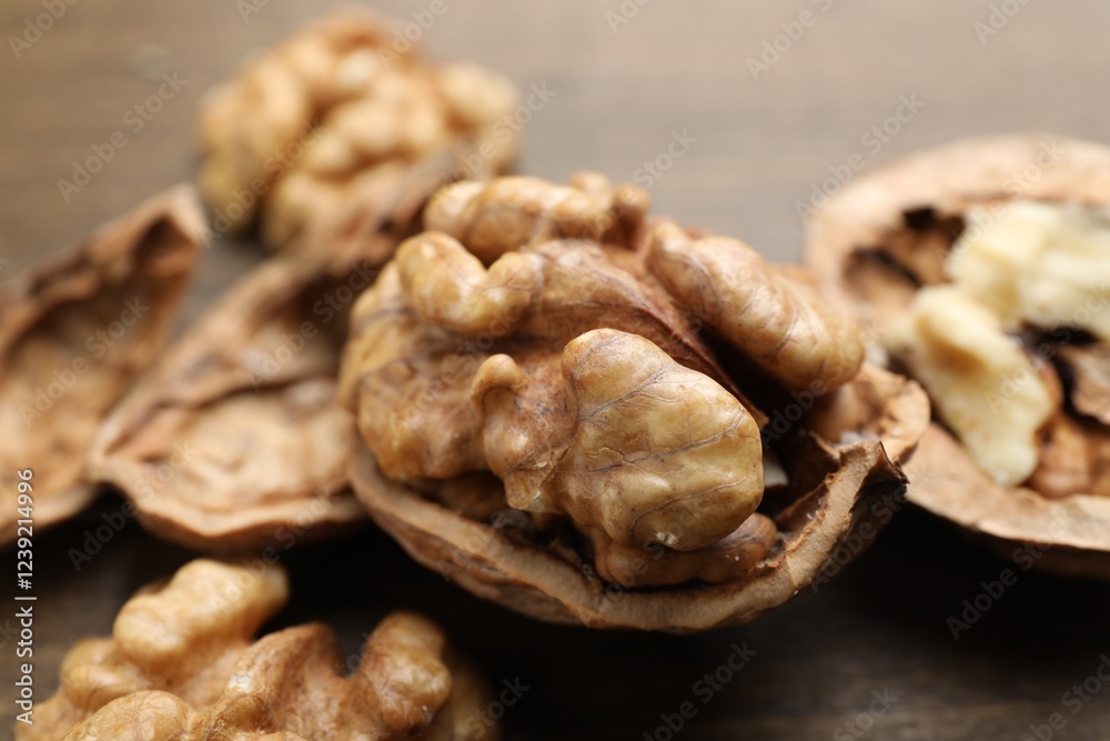 Fresh walnuts with shells on table, closeup Fresh walnuts with shells on table, closeup