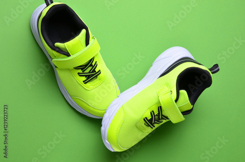 Light green sneakers on a bright background.