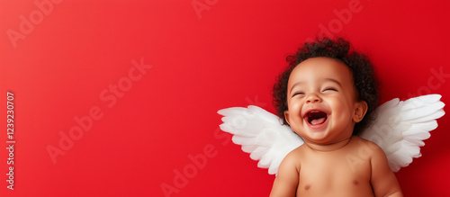 laughing African black baby angel cupid with white wings on red, valentines day sale and promotion. photo