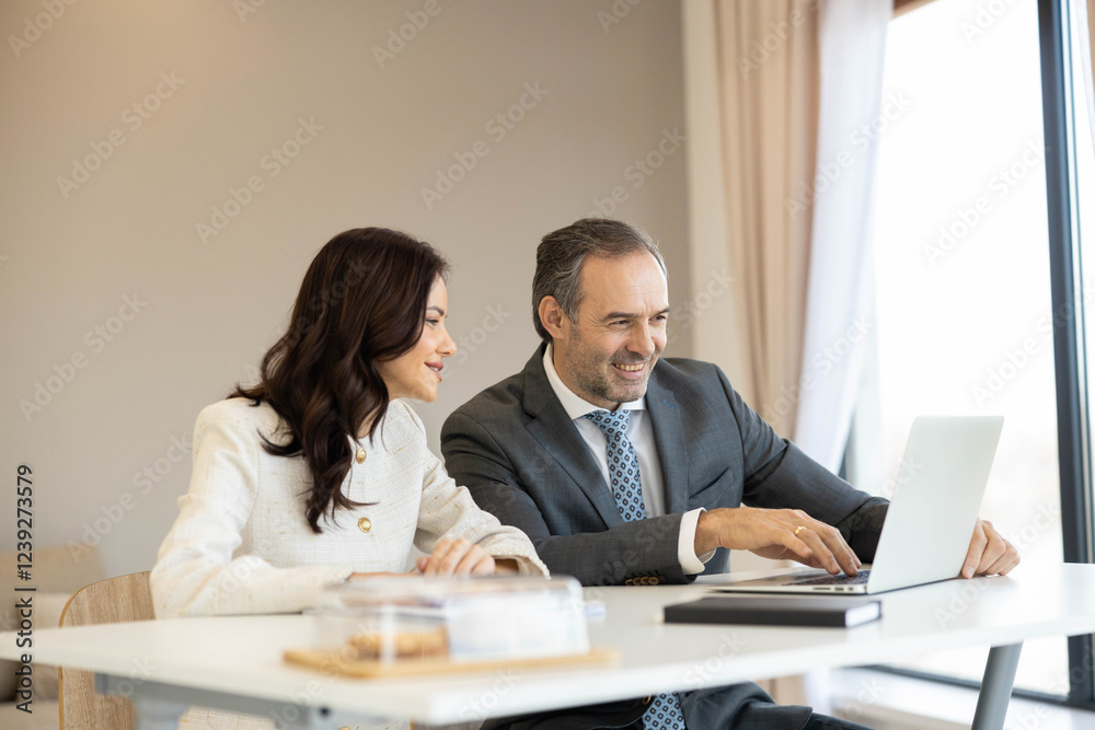Showcasing a collaborative meeting in a bright workspace, a man and woman actively share ideas and insights while working together on a project. Showcasing a collaborative meeting in a bright workspace, a man and woman actively share ideas and insights while working together on a project.