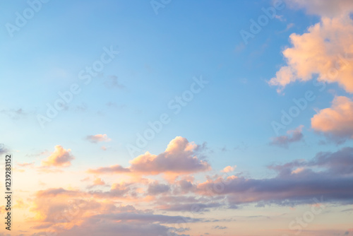 Fototapeta Naklejka Na Ścianę i Meble -  Blue sky with clouds illuminated by the setting sun. Beautiful skyscape