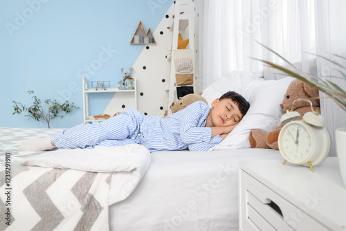 Cute little boy with alarm ...