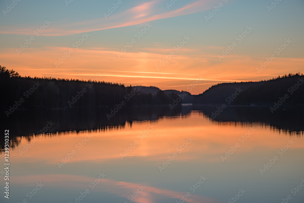 Lake scenery around sunset on a late spring evening in conifer forests of Finland Lake scenery around sunset on a late spring evening in conifer forests of Finland