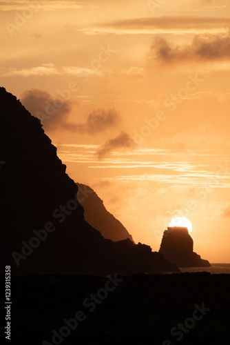 Photos Sun rises behind the Motu Marotiri Stake and Cape Roggeveen on the southern side of Poike Peninsula, Rapa Nui (Easter Island), Chile