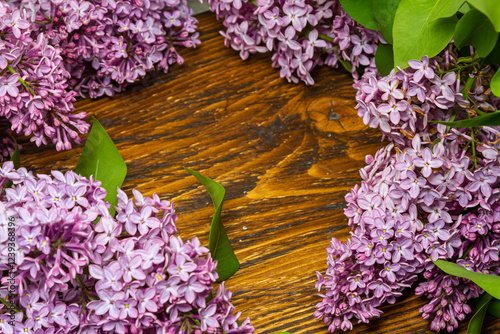 Beautiful spring flowers lilac on a wooden vintage board with place for text. Syringa vulgaris. Happy Mother's Day greetings card.