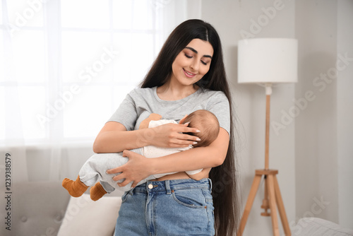 Young mother breastfeeding ...