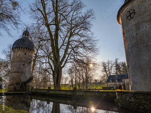 15th Century  medieval tower above water at sunset photo