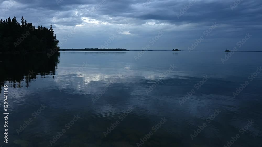 Late blue hour view of a calm peaceful northern lake with trees on shore and small islands
Late blue hour view of a calm peaceful northern lake with trees on shore and small islands