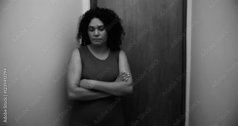 Black and white portrait of a woman leaning against a door, arms crossed, expressing emotional depth, introspection, and quiet resilience in a private moment Black and white portrait of a woman leaning against a door, arms crossed, expressing emotional depth, introspection, and quiet resilience in a private moment