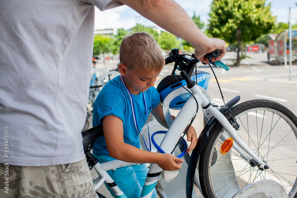 A young child works on a bicycle, fully absorbed in the process of fixing and learning. Perfect for illustrating productive activities, childhood curiosity, and family-oriented hobbies. A young child works on a bicycle, fully absorbed in the process of fixing and learning. Perfect for illustrating productive activities, childhood curiosity, and family-oriented hobbies.